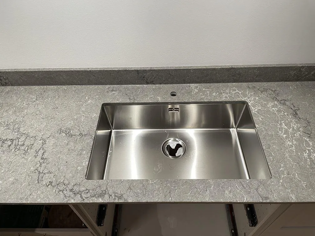 Köksbänkskiva i Caesarstone Turbine Grey med underlimmad rostfri diskho i ett kök i Västra Frölunda.