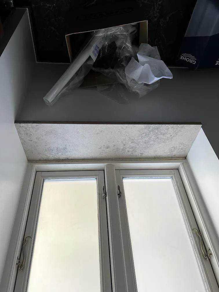 Underlimmad svart diskho infälld i en köksbänkskiva av Dekton Arga, polerad yta, i ett kök i Frederiksberg.