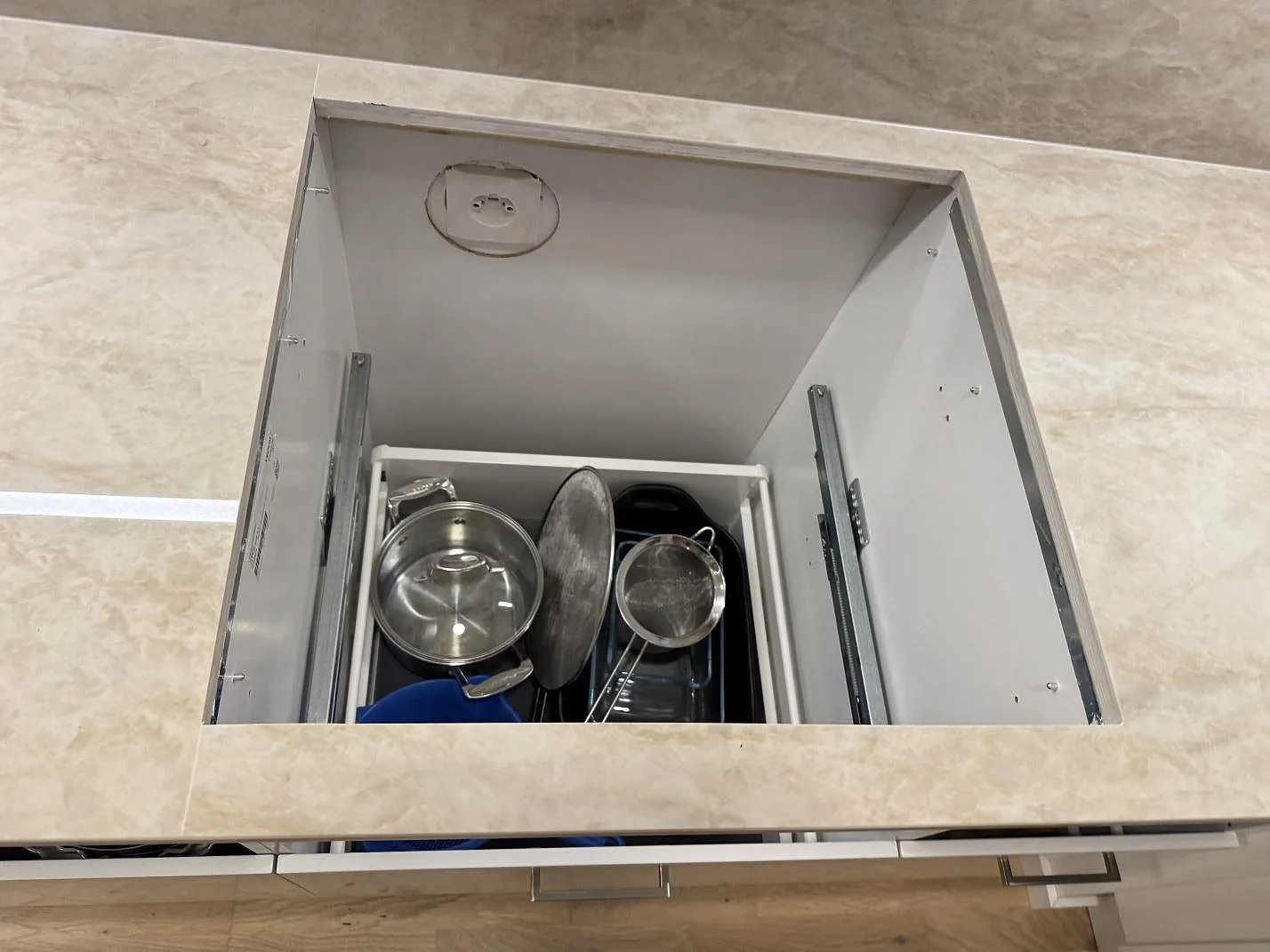 Detalj av öppet hälluttag i polerad Dekton Arga keramik med beige ådring och stänkskydd under montering i Lomma.