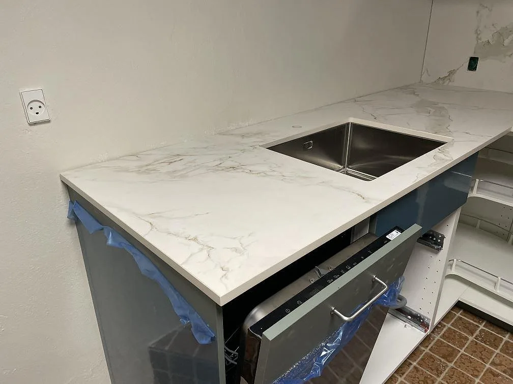 Matt Dekton Entzo köksbänkskiva med underlimmad rostfri diskho, blå stommar och terrakottafärgat klinkergolv i København K.
