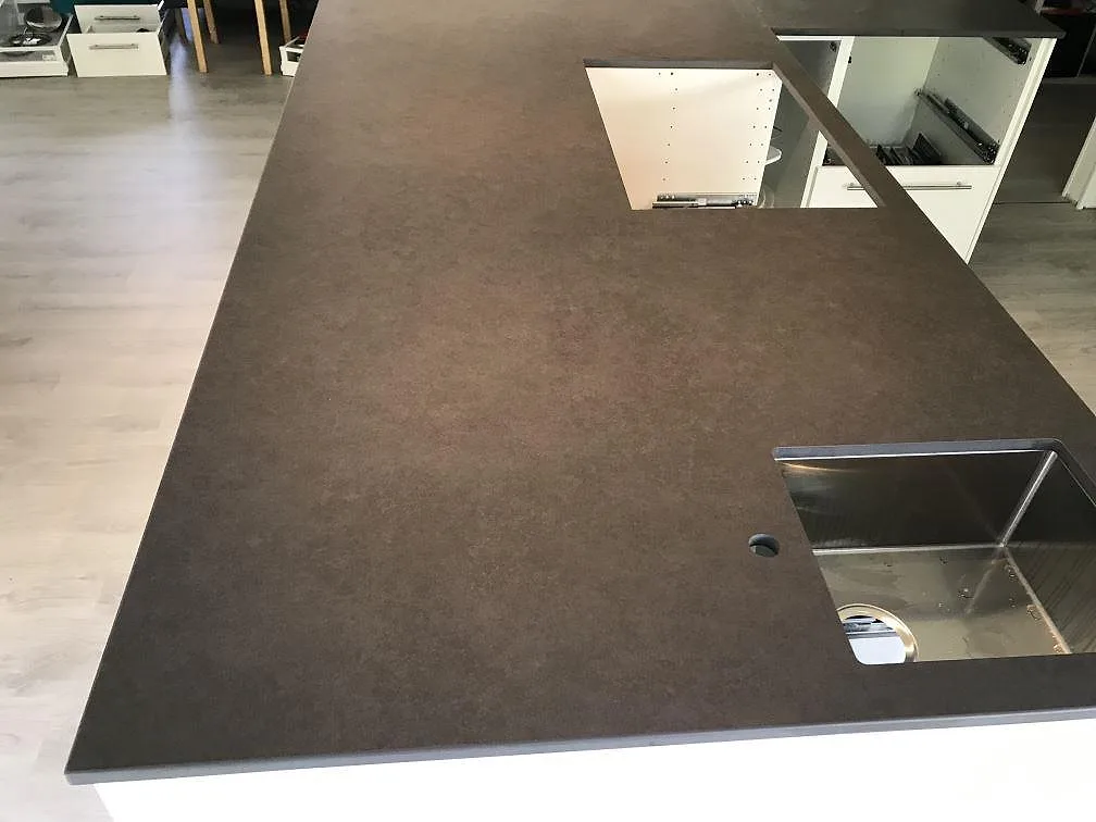 Stor köksö med 20 mm Dekton Eter i Mocka, med synlig diskho och hällöppning i Karlshamn.