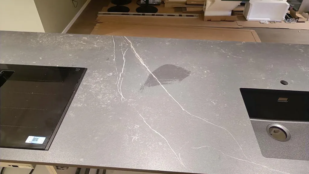 Detalj av köksbänkskiva i matt Dekton Kelya med häll, underlimmad diskho och ljus ådring i Kungsbacka.