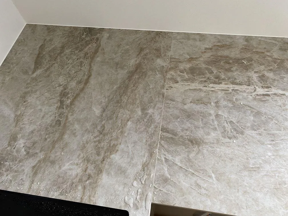Närbild på skarv och ådring i matt Dekton Kelya köksbänkskiva under montering i Viby Sjælland.