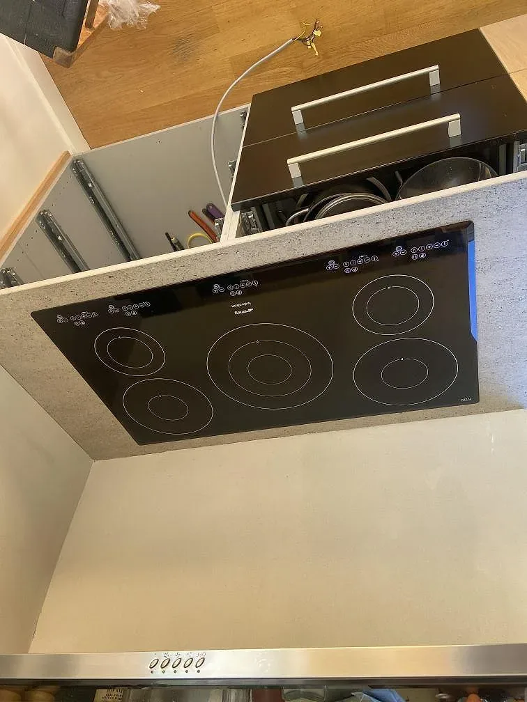 Köksbänkskiva i grå Dekton Keon med fönster och växter i ett kök i Rinkaby under montering.