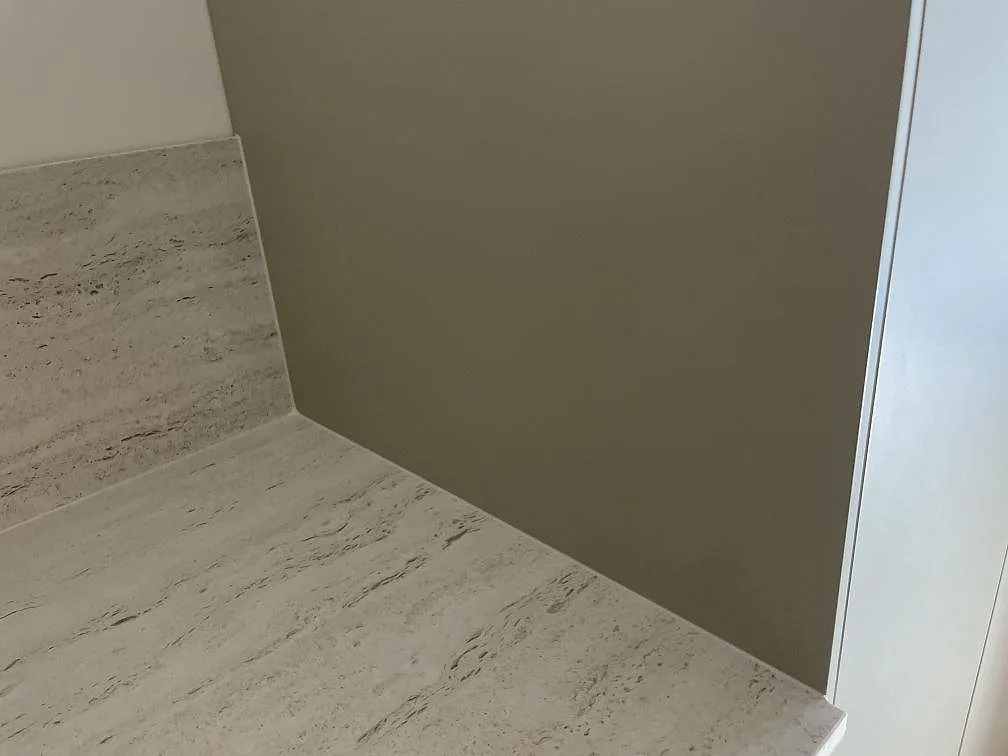 Närbild på matt Dekton Marmorio köksbänkskiva och stänkskydd vid sidovägg i Malmö.