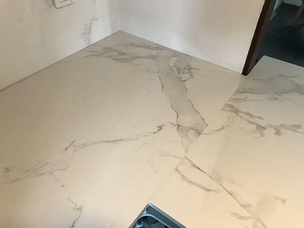 Köksbänkskiva i Dekton Natura som vänder runt ett hörn, polerad keramik med ådring, i ett kök i Bara.
