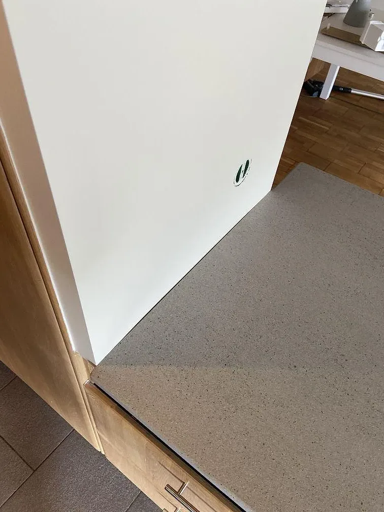 Detalj av ljus matt Dekton Strato intill vit yta och träinredning i ett kök i Trelleborg.