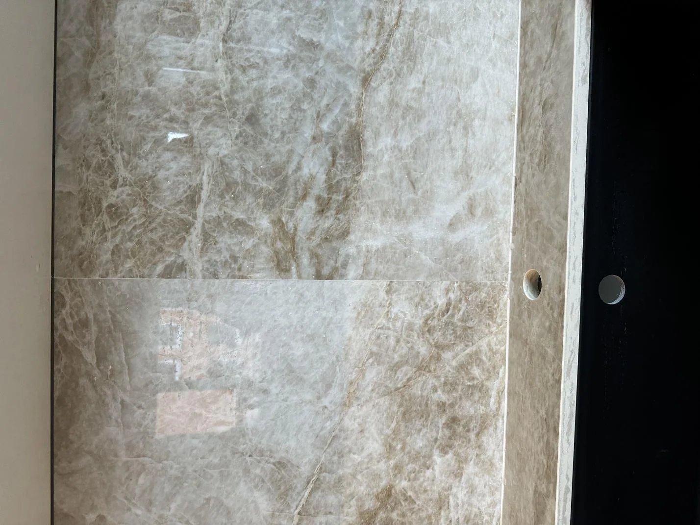 Sidovy av polerad Dekton Taga som väggbeklädnad vid köksbänken i Malmö.