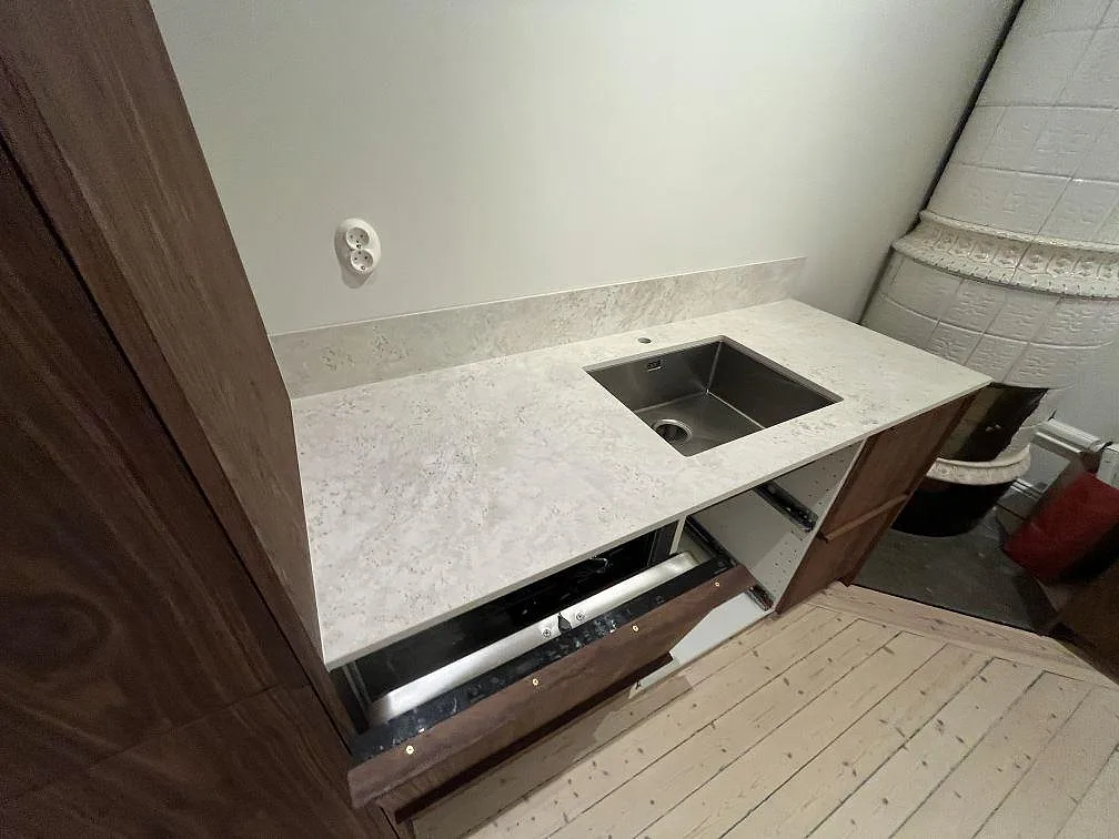 Köksbänkskiva i matt Dekton TK05 Sabbia med underlimmad rostfri diskho och lågt stänkskydd i Stockholm.