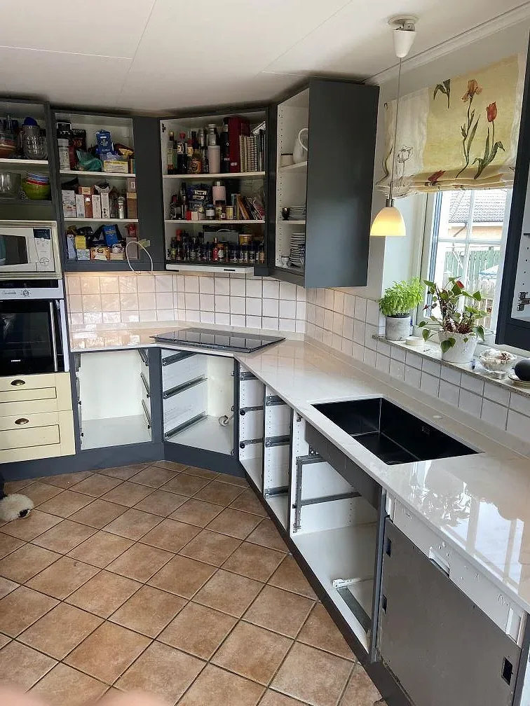 Vit marmorerad köksbänkskiva i polerad Dekton Tundra 19, keramik, med rostfri diskho och svart häll i Löddeköpinge.