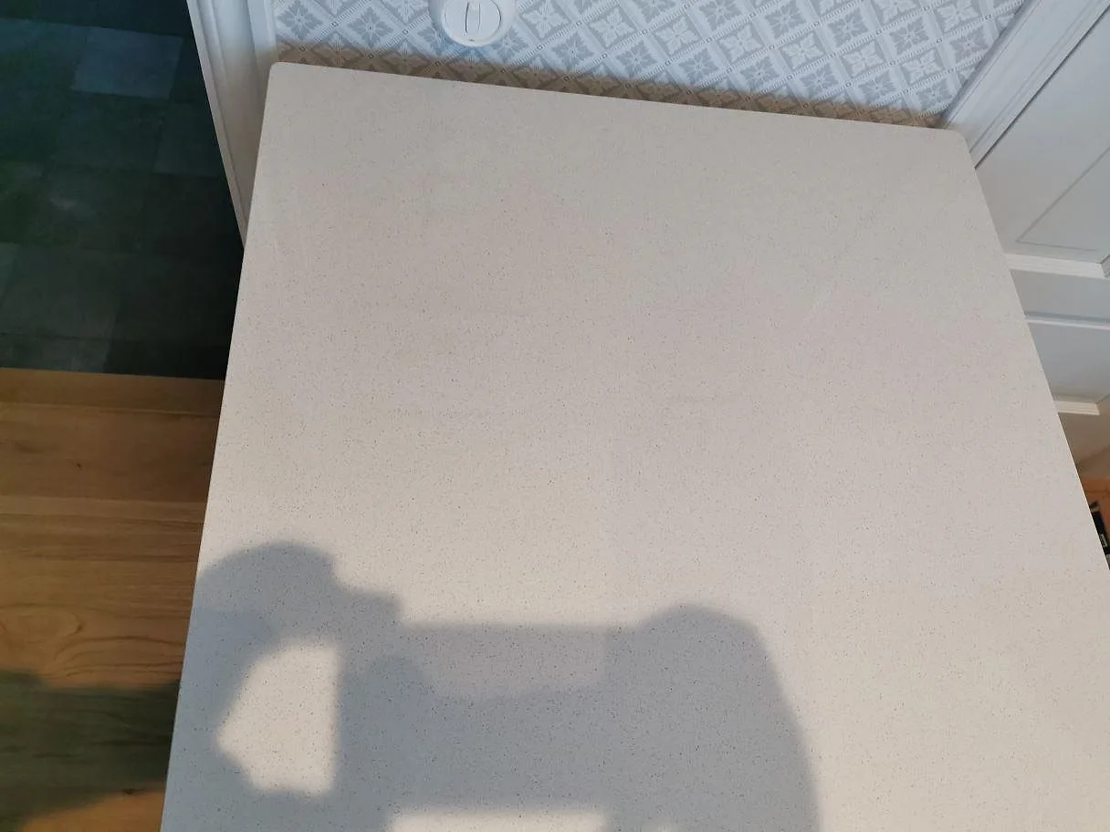 Detalj av hörn och kant på köksbänkskivan i Dekton Vienna keramik med rundat hörn och rakfasad kant i ett kök i Kungshamn.
