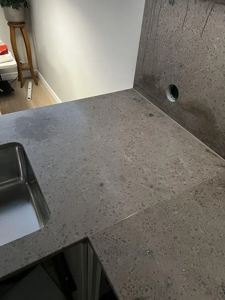 Köksbänkskiva i matt Jura Grey med rostfri diskho och grå fossilådring i Landvetter.