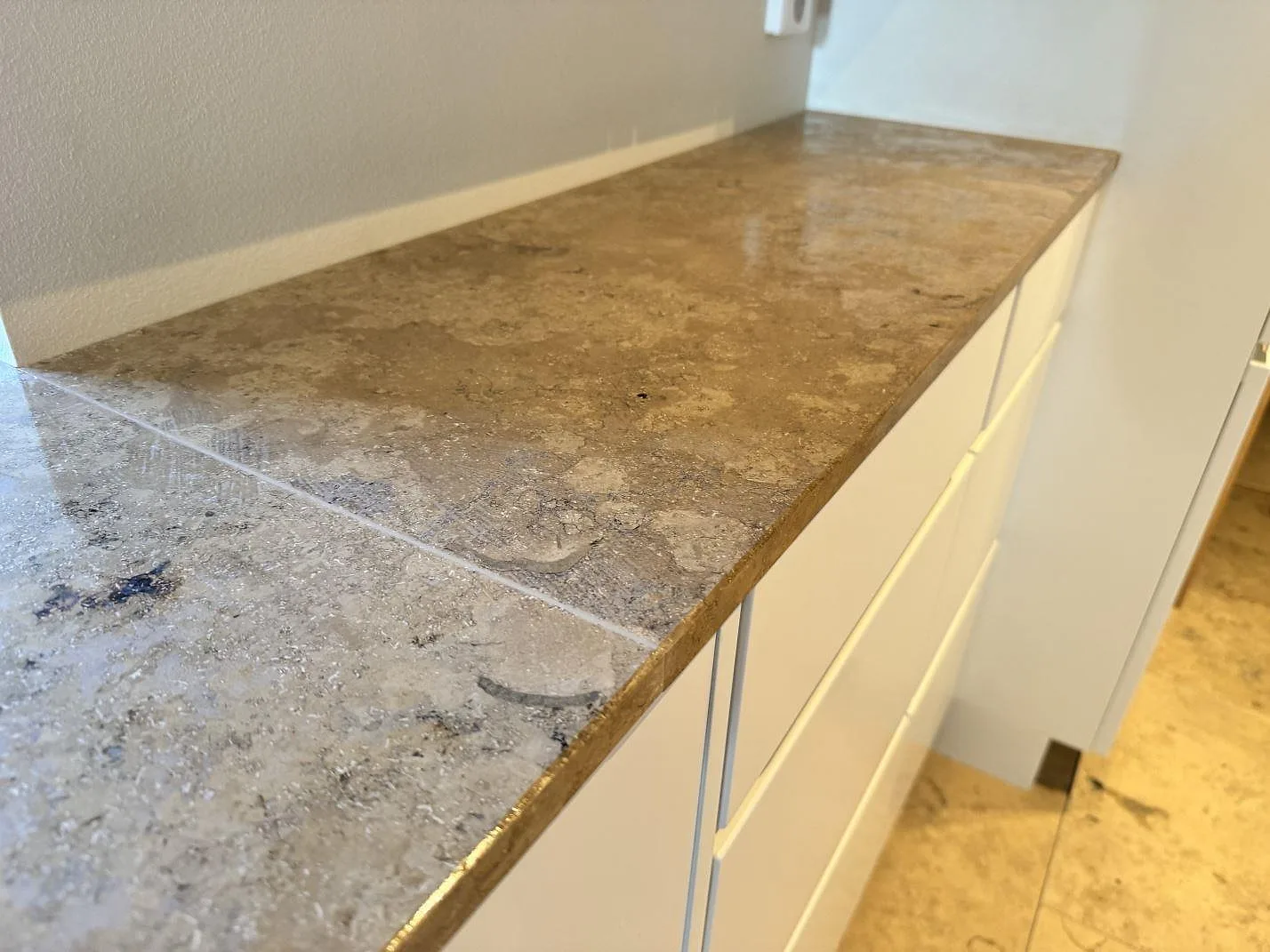 Detalj av köksbänkskiva i matt Jura Grey kalksten med rak framkant och synlig stenstruktur i Malmö.