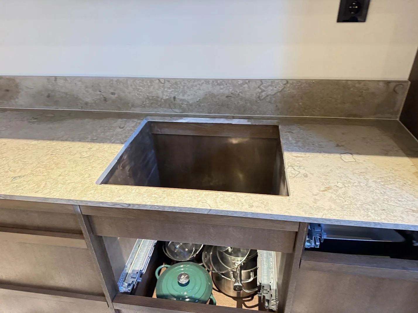 Installerad köksbänkskiva i matt Jura Grey med utskuret hoområde och uppvikt stänkkant i Malmö.