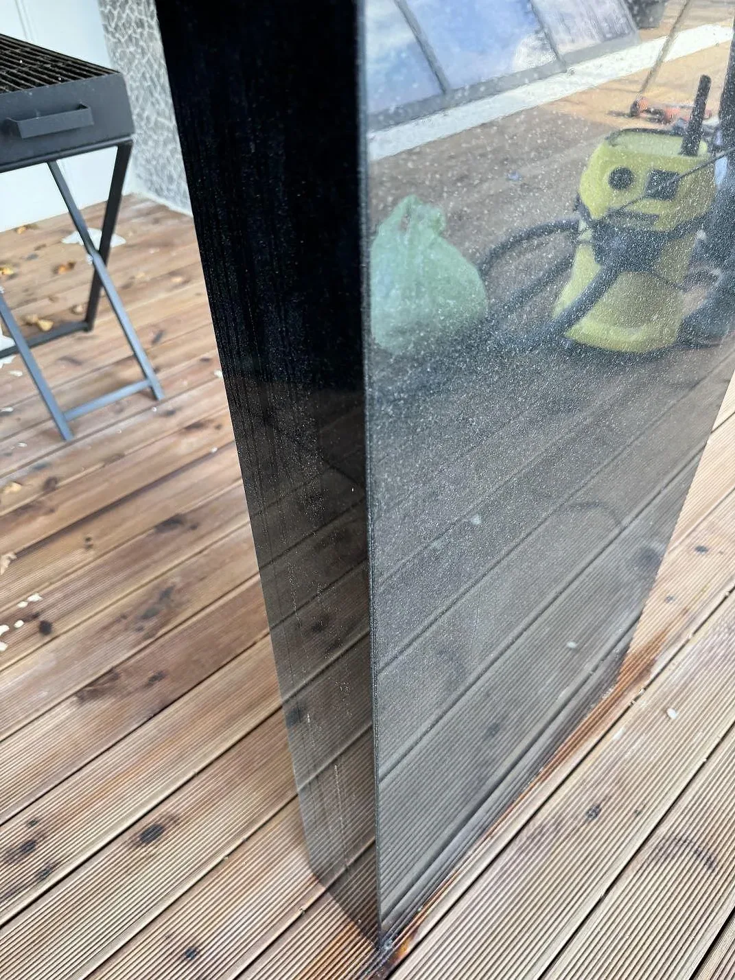 Blank svart Nero Assoluto granit med finprickig yta och tydlig reflektion av terrassen i Bara.
