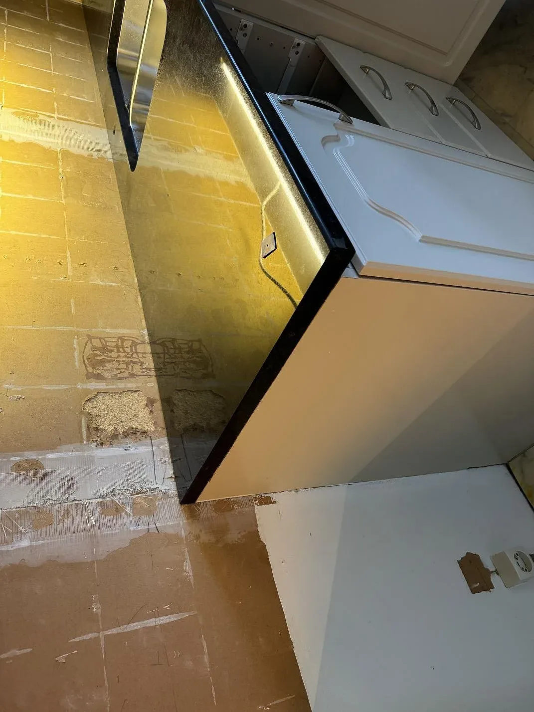 Detalj av polerad Nero Assoluto granit vid diskzon och väggyta i ett kök i Malmö.