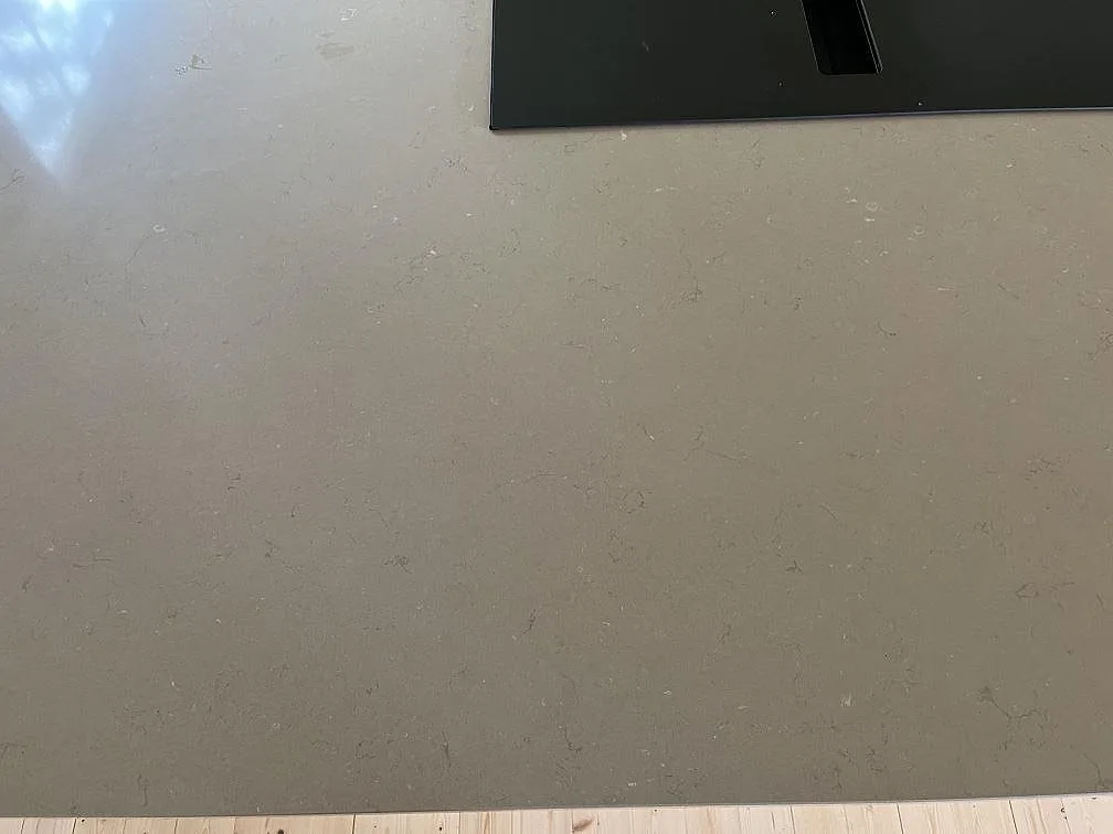 Köksbänkskiva i Silestone Coral Clay med infälld svart induktionshäll sedd ovanifrån i Hestra.