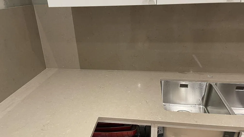 Polerad Silestone Coral Clay som köksbänkskiva och stänkskydd vid diskhozonen i ett kök i Karlskrona.