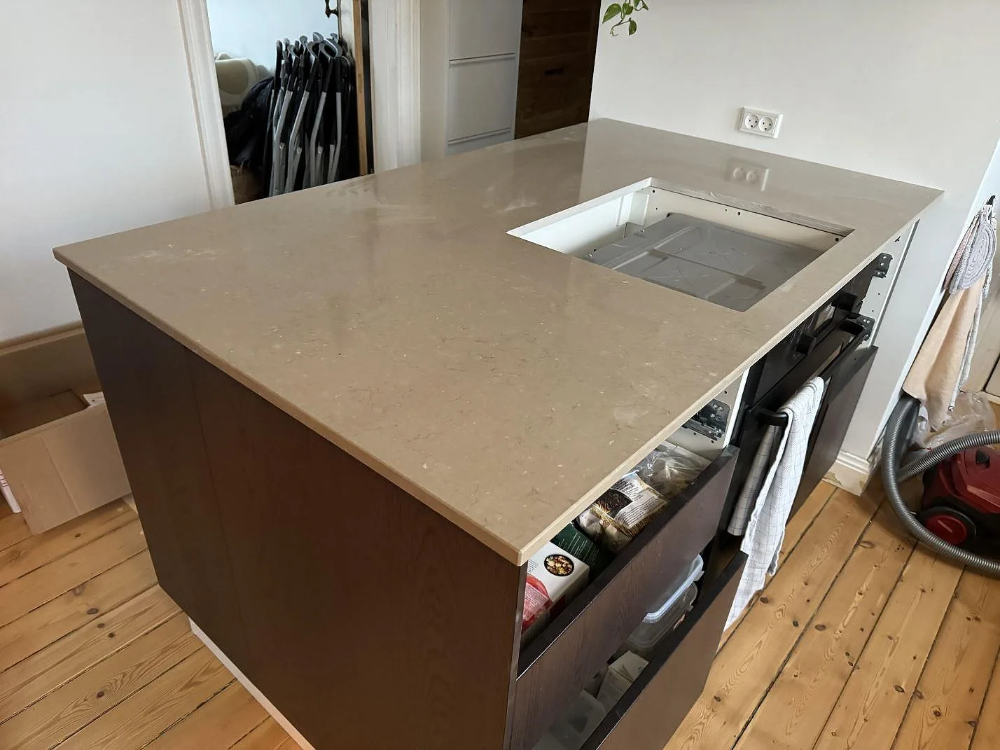 Köksö med polerad köksbänkskiva i Silestone Coral Clay, 20 mm komposit, med förberedd hällöppning i ett kök i Kastrup.