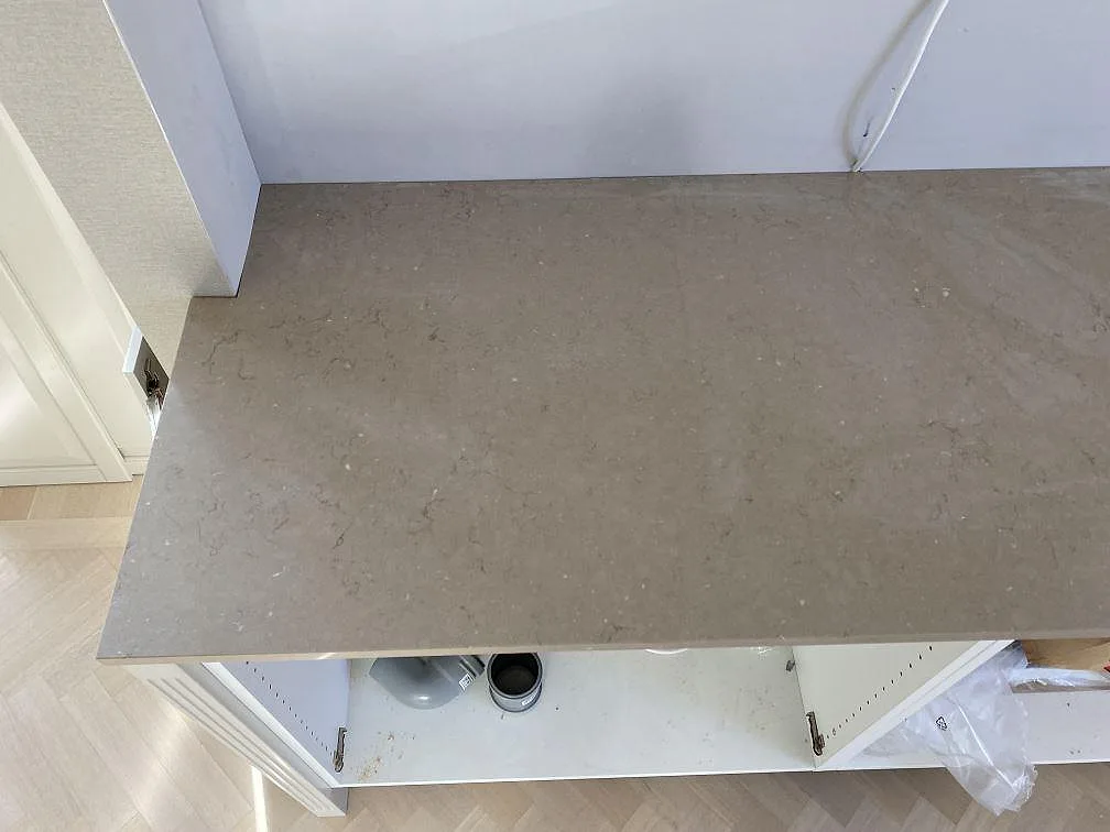 Topvy över greige Silestone Coral Clay bänkskiva med diskret ådring och polerad yta i ett kök i Landskrona.