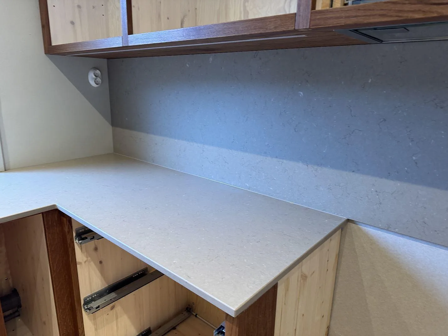 Närbild på matt Silestone Coral Clay som köksbänkskiva med 12 mm stänkskydd under överskåp i Sösdala.
