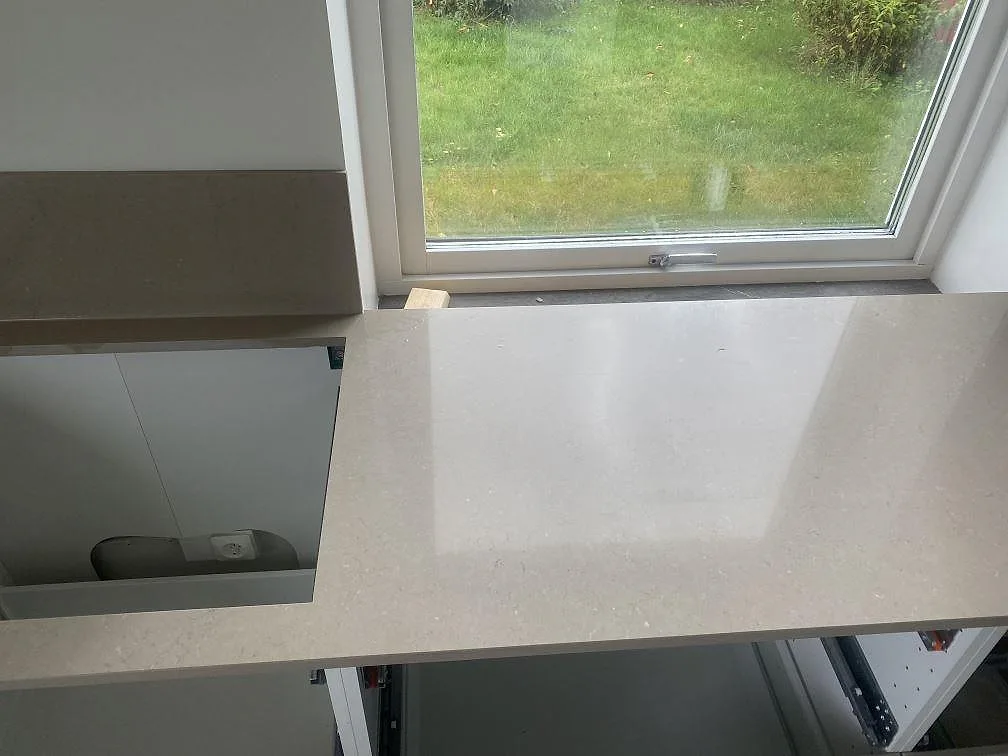 Ovanvy av installerad bänkskiva i Silestone Coral Clay vid fönstret i ett kök i Vellinge.