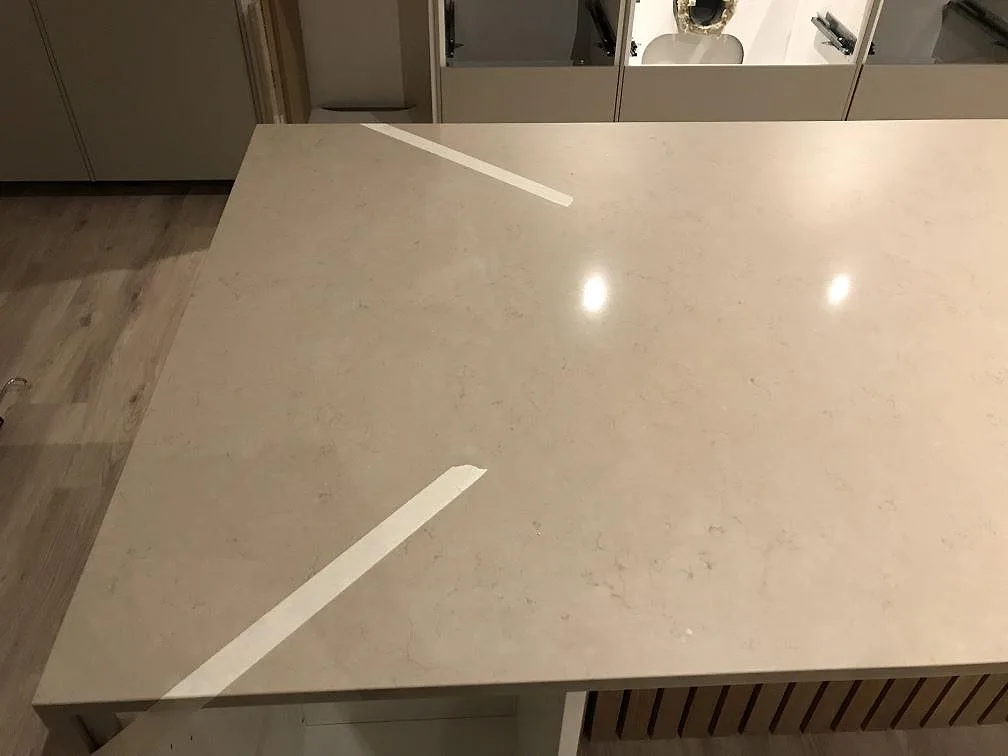 Köksö i Silestone Coral Clay sedd ovanifrån, polerad varm greige yta med ådring i ett kök i Vrigstad.