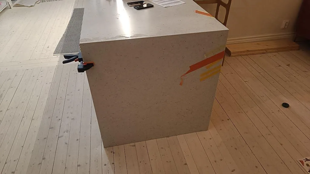 Köksö med topp och sidostycke i Silestone Lime Delight, 20 mm Mocka kvartskomposit, under montering i Lund.