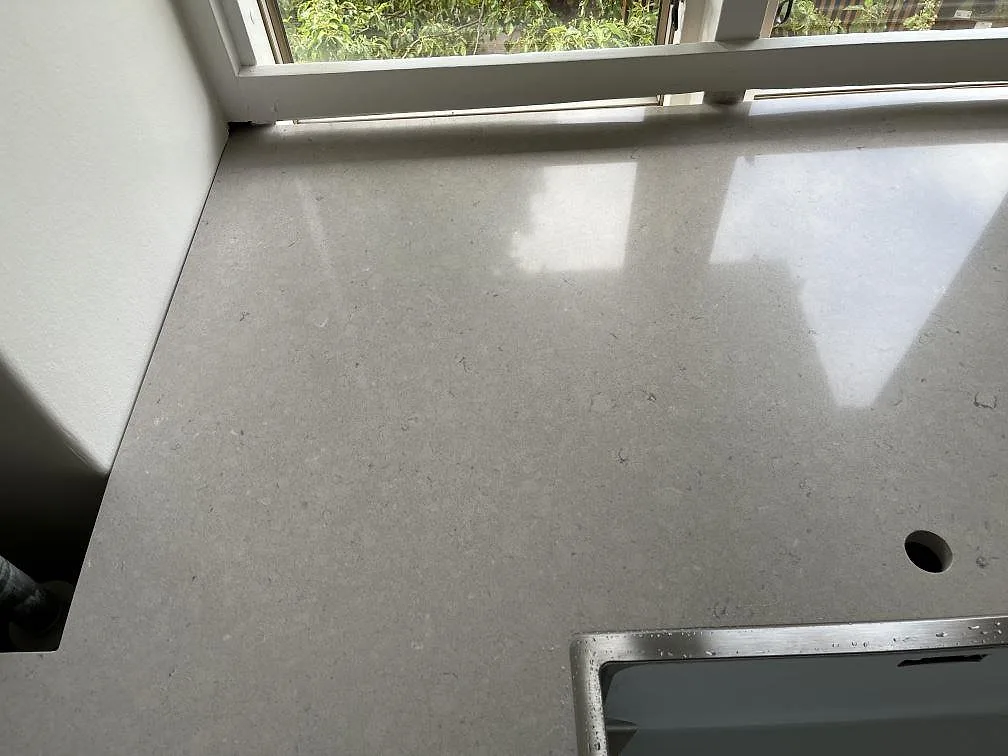 Polerad köksbänkskiva i Silestone Royal Reef med underlimmad diskho och separat blandarhål vid fönstret i ett kök i København N.