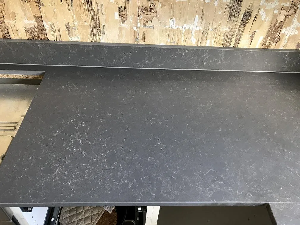 Bänkyta i grå Silestone Seaport kvartskomposit med diskret ljus ådring, matt mocka, ovanljus topbild av den installerade köksbänkskivan i Hisings-Kärra.