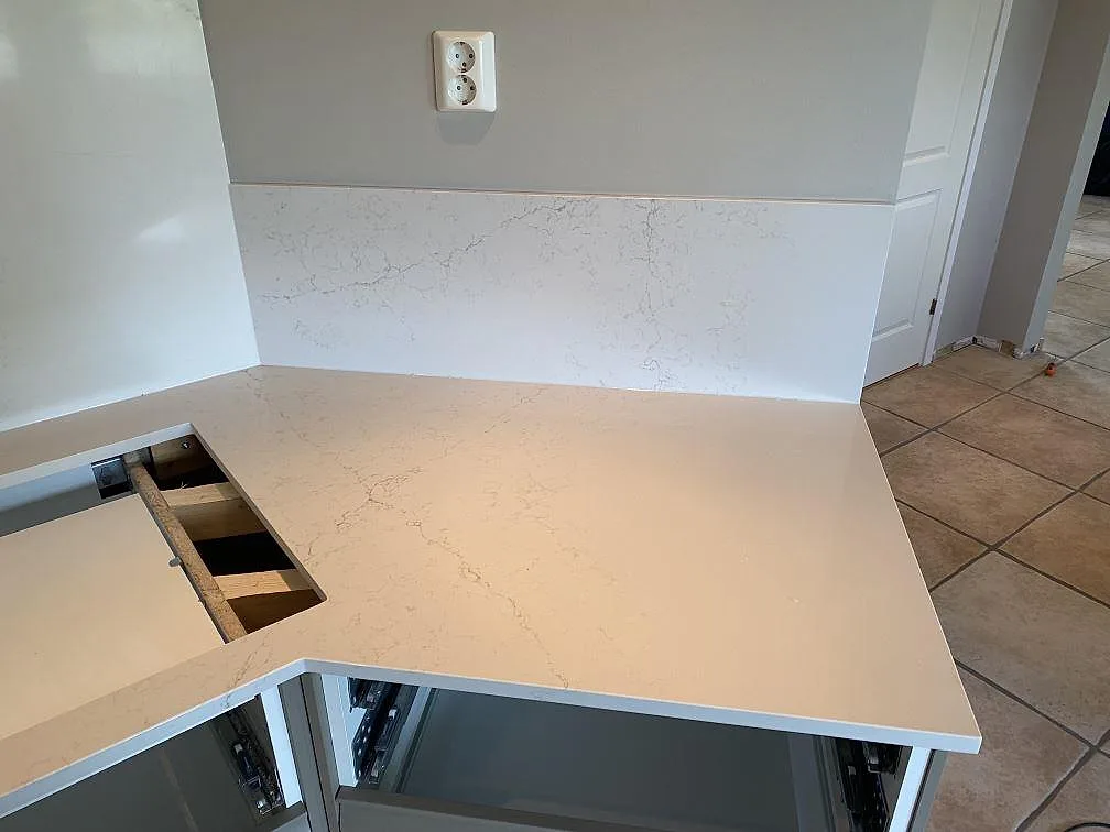 Höger bänkyta i polerad Silestone Siberian frost med 12 mm stänkskydd och synlig grå ådring i Veberöd.