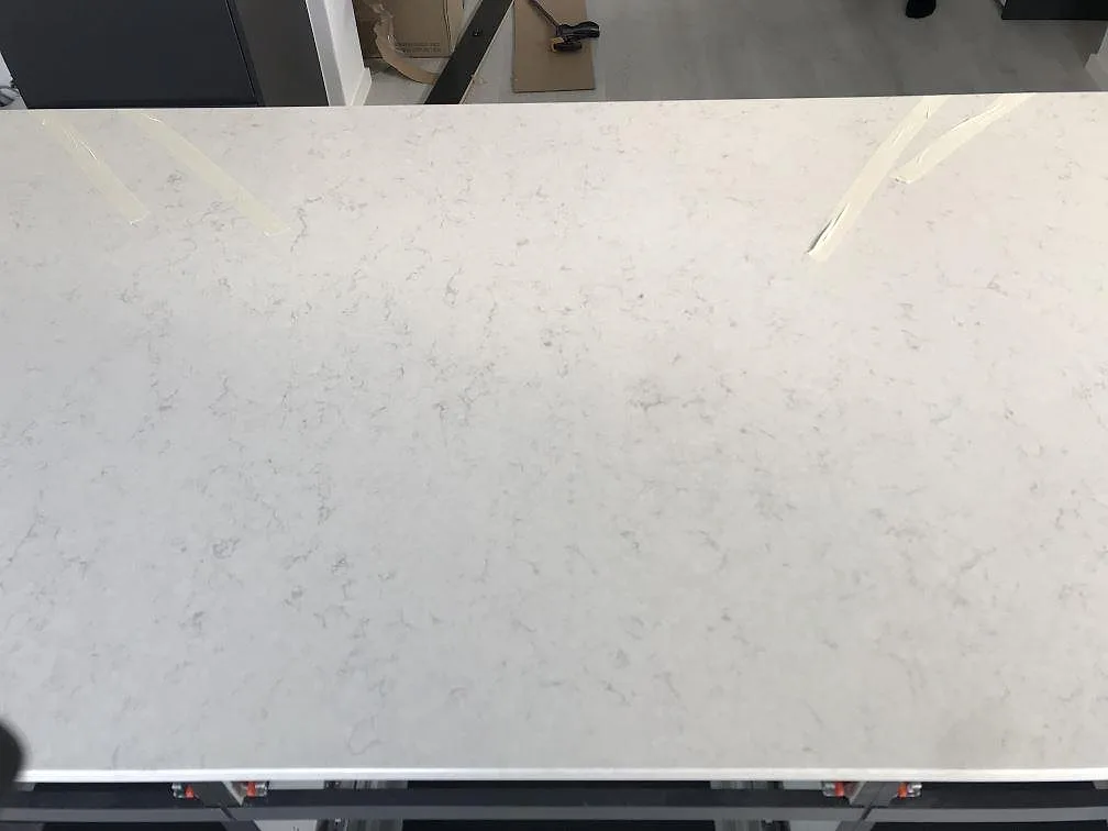 Polerad yta i vit Silestone Snowy Ibiza med mjuk grå ådring sedd ovanifrån i ett kök i Häljarp.