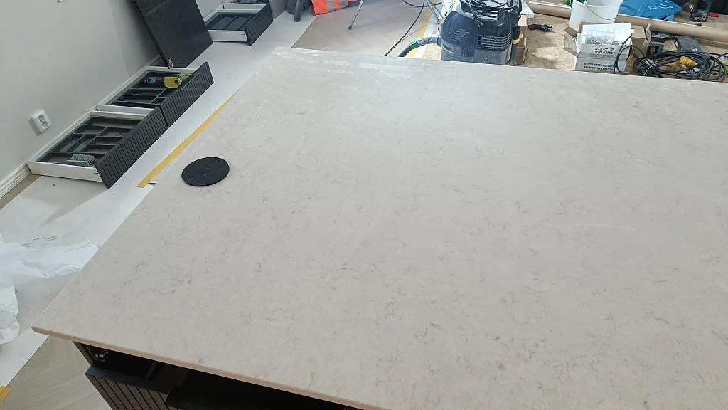 Stor sammanhängande köksö i polerad Silestone Snowy Ibiza med blank ljus kvartskomposityta i Löddeköpinge.