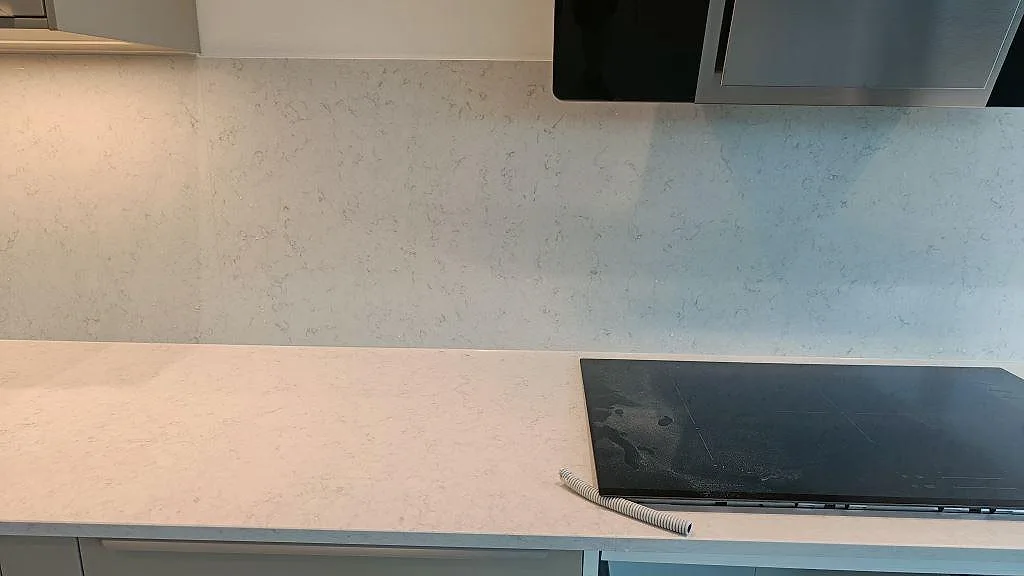 Silestone Snowy Ibiza köksbänk i Lund med induktionshäll och fläkt, fotograferad under montering innan elen var inkopplad.