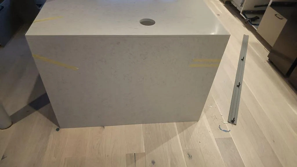 Köksö i Silestone Snowy Ibiza ovanifrån med håltagning för blandare och tejpade kanter i Malmö.