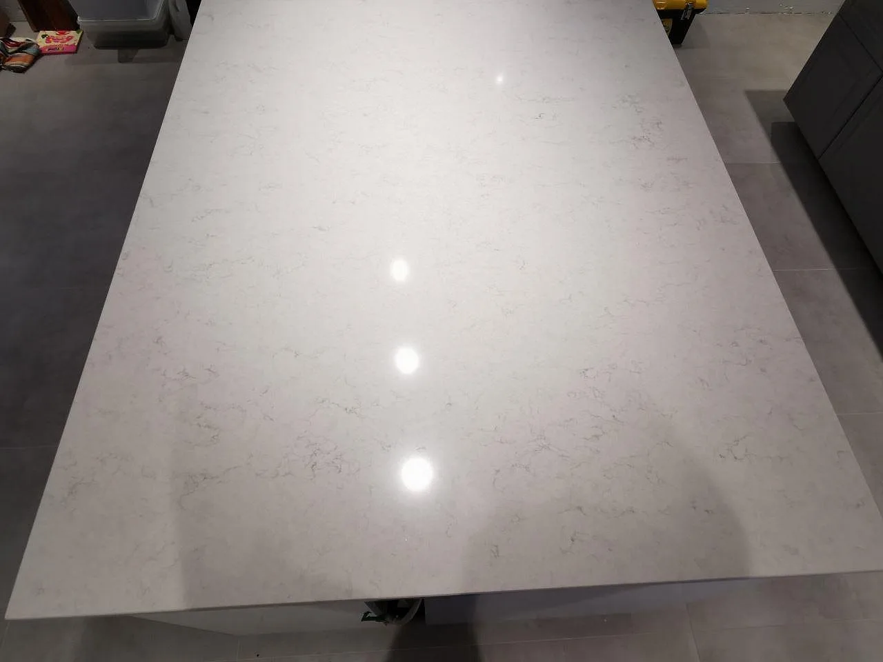 Topbild på köksön i polerad vit Silestone Snowy Ibiza med mjuk grå marmorering i ett kök i Sjöbo.