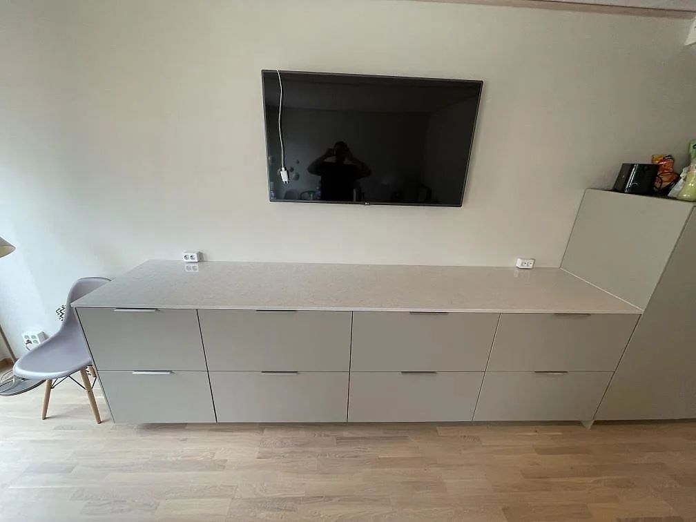 Rak bänkskiva i 20 mm Silestone Snowy Ibiza, polerad kvartskomposit, monterad över ljusa möbelfronter i Sundbyberg.