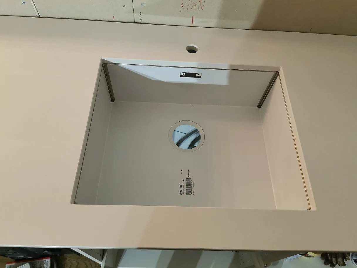 Underlimmad rostfri Blanco Zerox-diskho och blandarehål i polerad köksbänkskiva av Technistone Crystal Absolute White i Båstad.