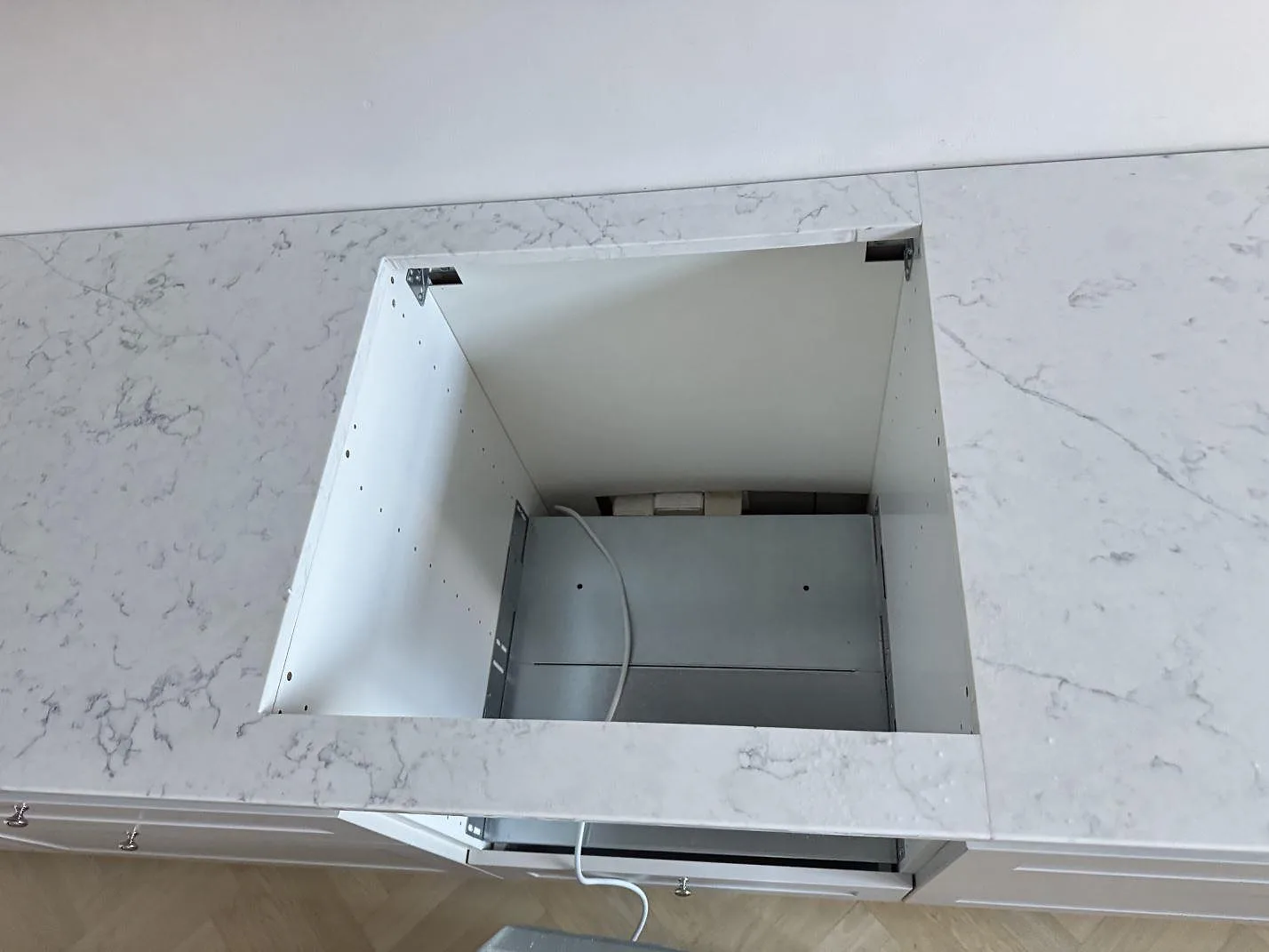 Topvy över stor öppning i polerad Technistone Mystery White, vit kvartskomposit monterad på köksstommar i Malmö.