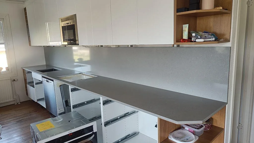 Rak köksbänkskiva i grå Technistone Noble Concrete Grey komposit, 20 mm, med matt bänkyta och blankt stänkskydd i Asmundtorp.