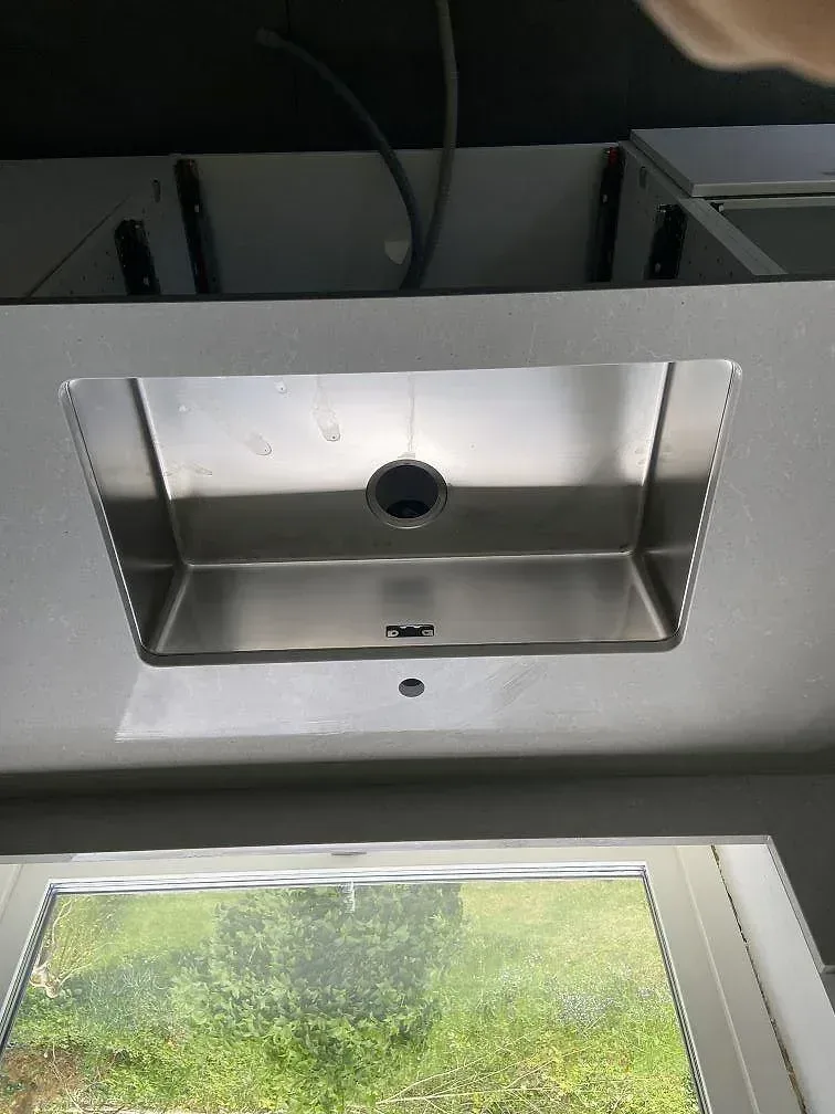 Underlimmad rostfri diskho infälld i grå Technistone Noble Concrete Grey köksbänkskiva i Kristianstad.