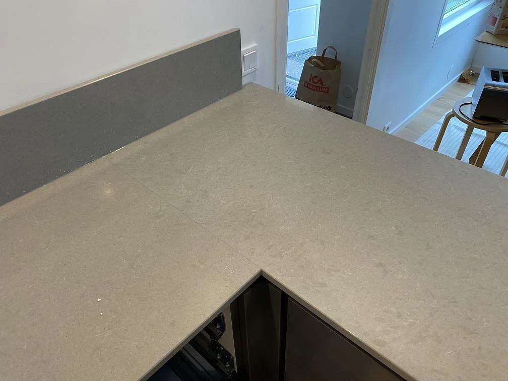 Topp på halvö i polerad Technistone Noble Concrete Grey bänkskiva i ett kök i Lund.