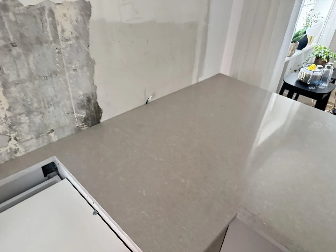 Topvy över köksbänkskiva i Technistone Noble Ivory White med hällöppning och halvö, polerad kvartskomposit i Helsingborg.
