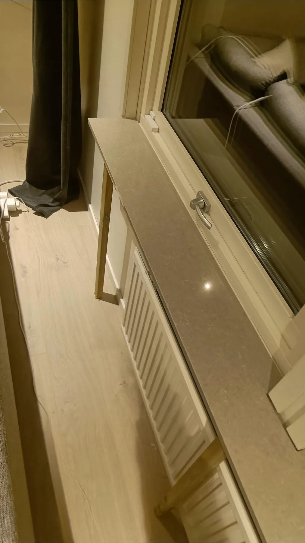 Polerad fönsterbänk i Technistone Noble Ivory White sedd längs fönstret, med subtil mönstring i kompositstenen i Löddeköpinge.