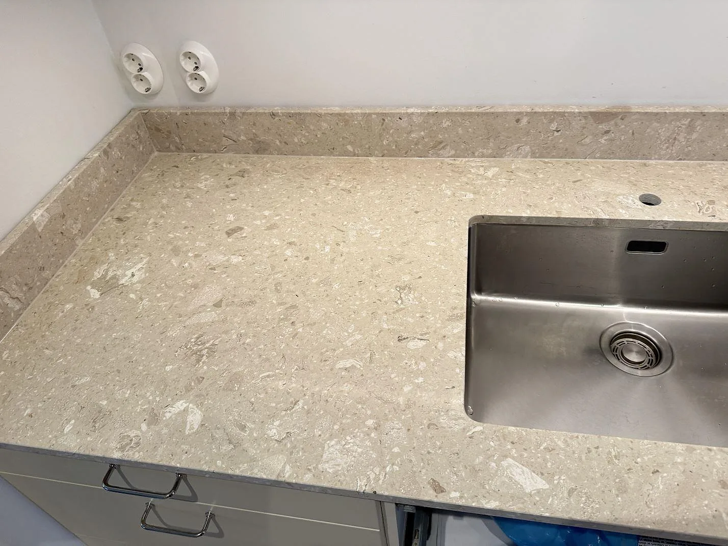 Matt köksbänkskiva i Terrazzo Perlato Royal med underlimmad rostfri diskho, blandarhål och stänkkant i Malmö.