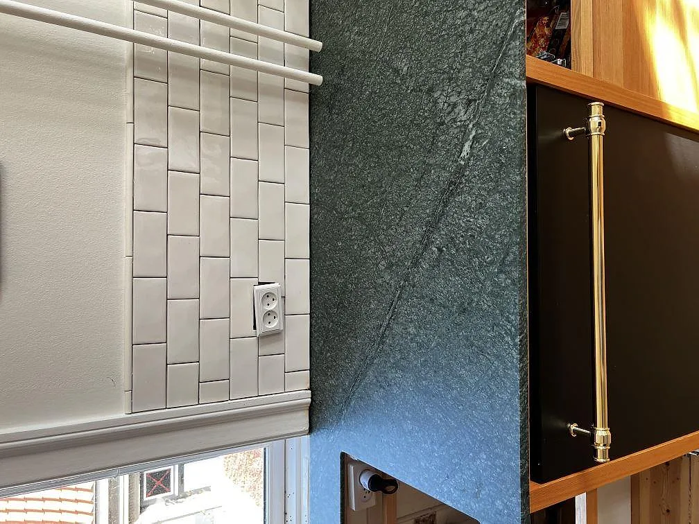 Installerad Verde Guatemala marmor runt arbetsyta och kakel vid fönster i kök i Fredriksberg.
